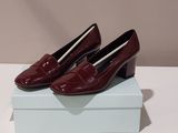 a pair of red shoes sitting on top of a white box