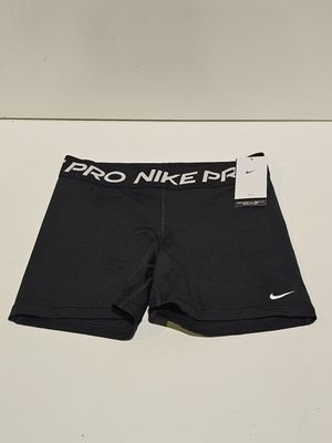 the nike pro shorts are black and white with a logo on the side