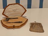 a purse that is sitting on a table next to a knife