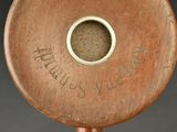 a close up of a wooden object with writing on it