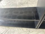 a black shelf that has two black shelves on it