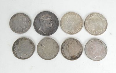 a close up of a group of coins on a white surface