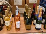 many bottles of wine sitting on a shelf in a store