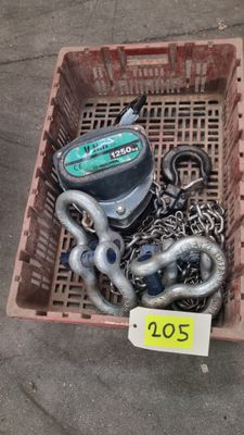 a box with chains and a boat engine in it