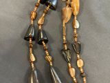 beaded necklace with black, brown, and gold beads and charms