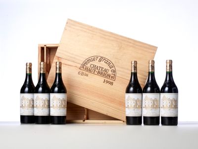 six bottles of wine in a wooden box with a white background