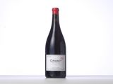 a bottle of red wine sitting on top of a table