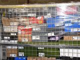 a metal cage with a bunch of boxes inside of it