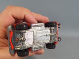 a person holding a toy truck in their hand