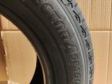 a close up of a tire on a wooden floor with a cardboard box in the background
