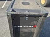 a trash can sitting in a parking lot next to other vehicles