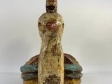 an image of a figurine of a woman sitting on top of a rock