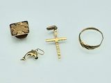 three rings, a cross, a ring, and a ring on a white surface