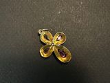 a close up of a yellow flower brooch with a diamond center