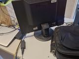 a bag and a laptop on a desk with a bag on it