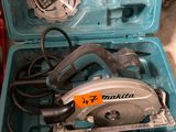 a blue tool case with a circular saw in it