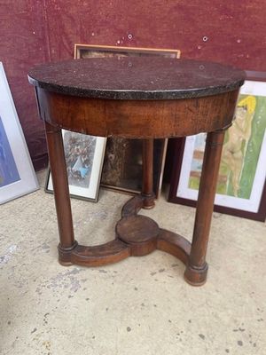 une petite table avec un plateau en marbre et un cadre photo