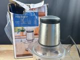 a silver blender sitting on top of a wooden table