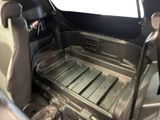 the interior of a car with a seat and a tray in it