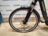 a bicycle that is parked in front of a wall