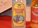 two bottles of tequila next to each other on a table