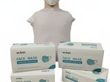une tête de mannequin avec trois boîtes de masques à côté