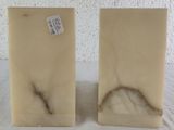 pair of white marble bookends on a white surface
