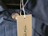the label on a blue jacket is attached to a button