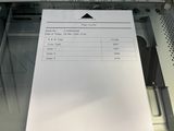 an image of a printer with a sheet of paper on it