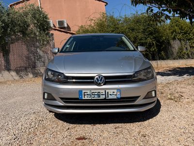 a silver car that is parked in front of a house