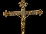 a close up of a cross on a black background with a black background