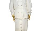 a mannequin dressed in a white suit on a wooden stand