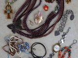 a lot of jewelry that is laying out on the floor