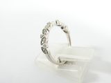 a close up of a silver ring on a clear stand