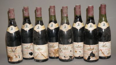 six bouteilles de vin sont alignées sur une table