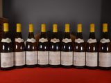several bottles of wine are lined up on a red table