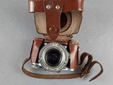 a brown leather case with a camera attached to it
