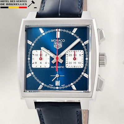 a close up of a watch with a blue face