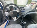 dashboard of a small car with a steering wheel and dashboard controls