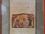framed picture of a painting of a man and a woman in a manger