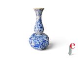 a blue and white vase sitting on a white surface