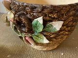 a vase with a bird on it sitting on a table