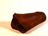 a small piece of rusted metal on a white surface