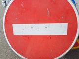 a red and white sign that is on the side of the road