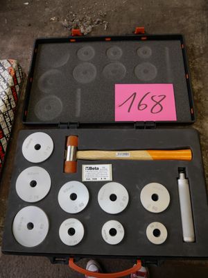 a case with a hammer, a hammer, and other tools in it