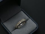 an image of a ring in a box on a black surface