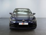 the front of a blue volkswagen golf r - line parked in a garage