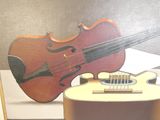 a painting of a guitar and a violin on display
