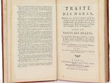 a book open on a white surface with a title in it