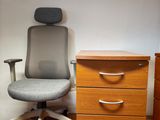 une image représentant un bureau avec une chaise et une commode